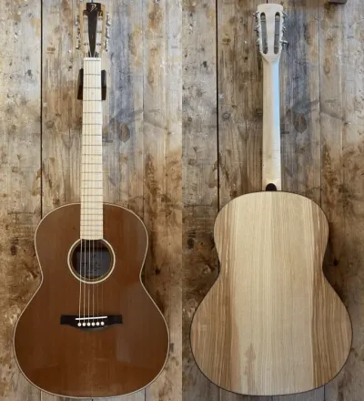 Front and back views of a wooden acoustic guitar against a rustic wood background.